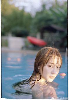Woman with wet hair in a swimming pool with soft lighting