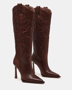 Pair of brown leather cowboy boots with high heels and embroidered details