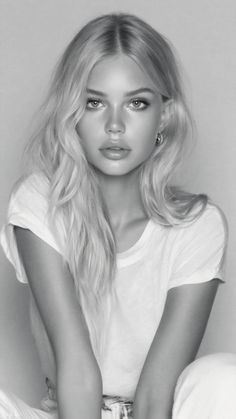 Blonde woman in a white t-shirt looking directly at the camera