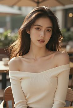Woman with long hair wearing an off-shoulder top outdoors