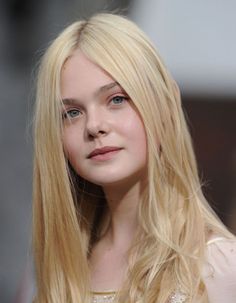 Young woman with long blonde hair and blue eyes looking directly at the camera