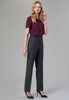 Woman with blonde hair wearing a short sleeve top and pinstripe pants