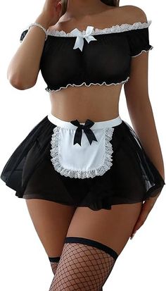 Woman in a black and white maid lingerie set with fishnet stockings