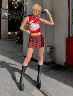 Woman with blonde hair in a crop top and mini skirt on a sunny street