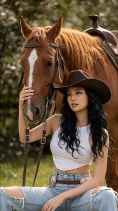 Woman in a cowboy hat and ripped jeans posing with a horse outdoors