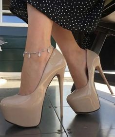 Woman wearing nude platform high heels and an anklet with a polka dot dress