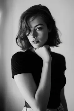 Black and white portrait of a woman with short hair and freckles