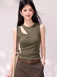 Woman with long dark hair wearing an olive green top and brown pants
