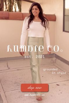 Woman with long dark hair wearing a white top and light green pants outdoors
