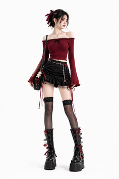 Woman in a dark red off-shoulder top and black mini skirt with platform boots