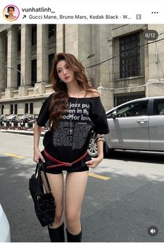 Woman with long hair wearing an off-shoulder top and shorts on a street