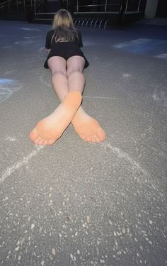 Person with long hair lying on the ground from behind