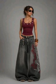 Woman in a maroon tank top and baggy jeans with tribal print