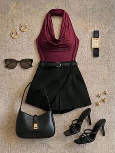 Flat lay of a fashion outfit with a maroon halter top and black shorts