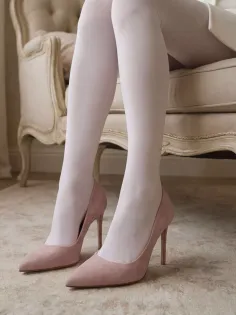Legs in white tights and pink high heels sitting on an elegant chair