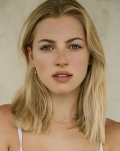 Close-up portrait of a woman with blonde hair and blue eyes