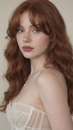 Woman with red hair and blue eyes wearing a sheer top