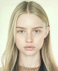 Young woman with blonde hair and blue eyes looking directly at the camera
