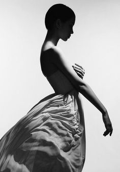 Woman in a strapless dress with short hair in a dramatic black and white profile shot