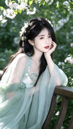 Woman in a light green hanfu with a flower crown outdoors