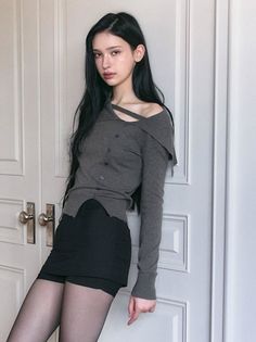 Woman with long black hair wearing an off-shoulder top and black skirt
