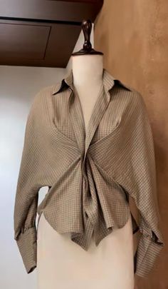 Plaid blouse with a unique knotted front displayed on a mannequin