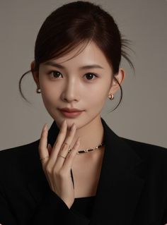 Woman in a black blazer with an updo hairstyle and gold jewelry