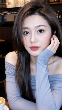 Woman with long hair wearing an off-shoulder top indoors