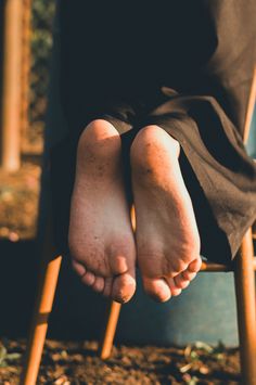 Bare feet with dirt on them, illuminated by golden hour light