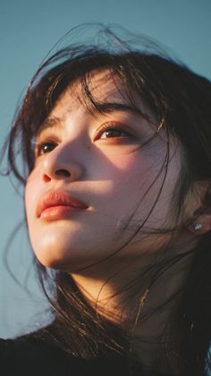 Close up portrait of a woman with dark hair in soft golden hour light