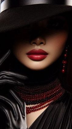Woman with red lipstick, black hat, and leather gloves in dramatic lighting