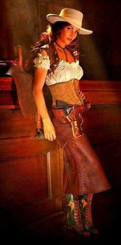 Woman in a cowgirl outfit with a corset and leather skirt in dramatic lighting
