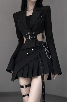 Woman in a black cutout jacket and pleated skirt with garter belt