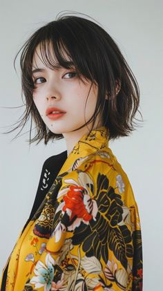 Woman with short wet hair wearing a yellow floral print shirt