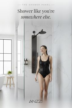 Woman in a black swimsuit showering in a modern bathroom