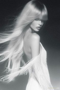 Woman with long blonde hair and a fringe dress in a monochrome portrait