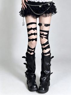 Person in gothic fashion with a black ruffle skirt, thigh-high socks, and combat boots
