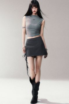 Woman with long black hair wearing a crop top, mini skirt, and cowboy boots
