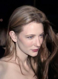 Woman with long blonde hair and red lipstick in a portrait shot