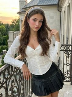 Woman with long hair and a headband on a balcony at golden hour