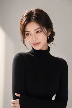 Woman in a black turtleneck with an updo hairstyle and earrings