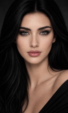 Woman with long black hair and grey eyes wearing an off-shoulder top