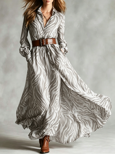 Woman in a flowing zebra print dress with a brown belt and boots