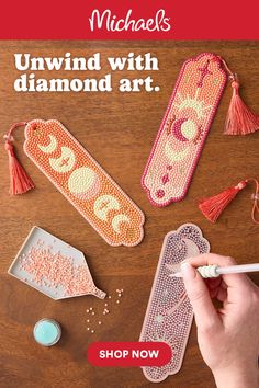 Diamond art bookmarks with moon phase designs on a wooden surface