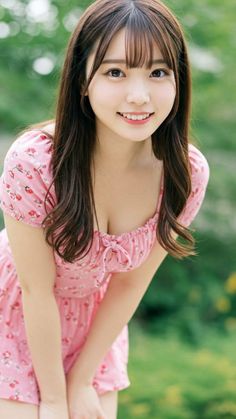 Woman in a pink floral dress with long hair outdoors