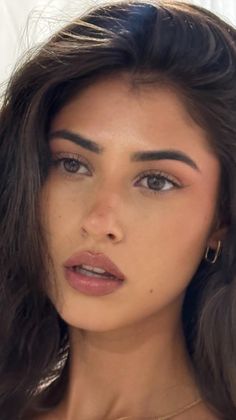 Close up portrait of a woman with dark hair and glossy lips