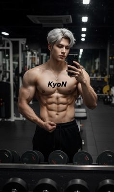 Muscular man with silver hair taking a selfie in a gym
