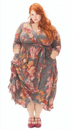 Woman with red hair in a floral dress and pink shoes on a white background