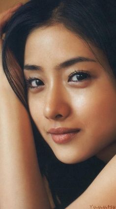 Close up portrait of a woman with long black hair and soft lighting