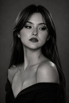 Woman with long hair and red lipstick wearing an off-shoulder top